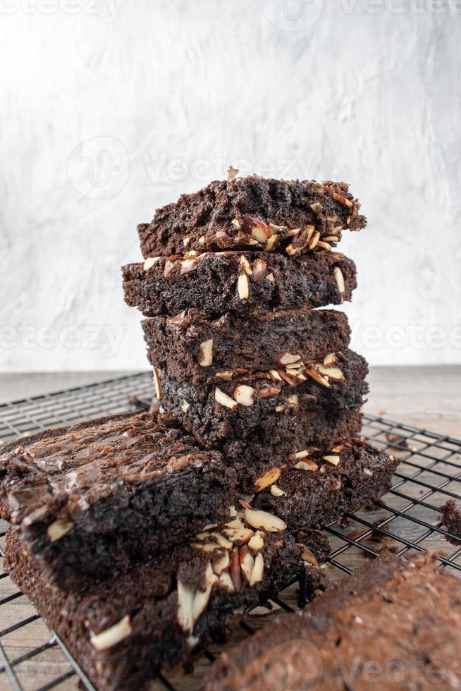 pilha de quadrados de brownie caseiro fatiado com amêndoas foto