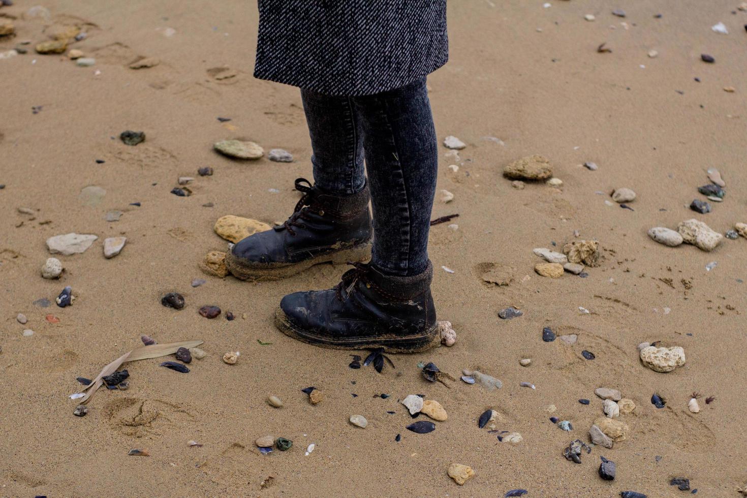 jovem de casaco cinza contra o fundo do mar outono foto