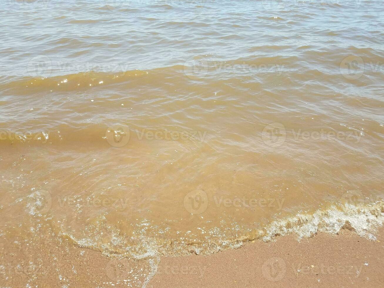 areia com ondas e pedras foto