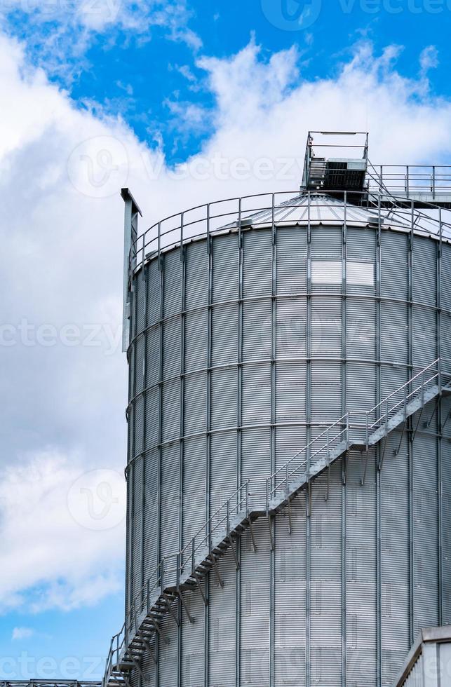 silo agrícola na fábrica de ração. grande tanque para armazenar grãos na fabricação de rações. torre de estoque de sementes para produção de ração animal. ração comercial para as indústrias de gado, suínos e peixes. foto