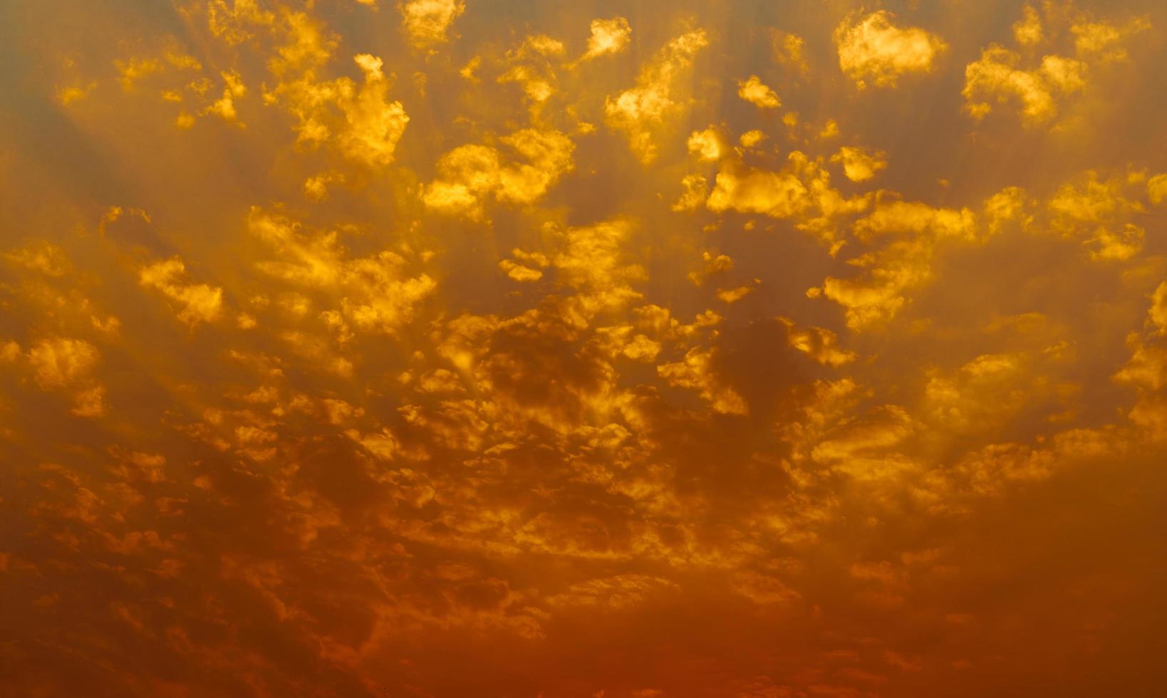 lindo céu por do sol. céu dourado do sol com belo padrão de nuvens. nuvens laranja, amarelas e vermelhas à noite. liberdade e fundo calmo. beleza na natureza. cena poderosa e espiritual. foto