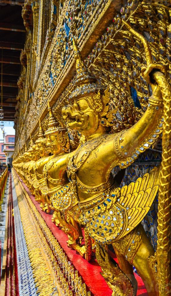 bela escultura de garuda dourada no grand palace, bangkok, tailândia foto