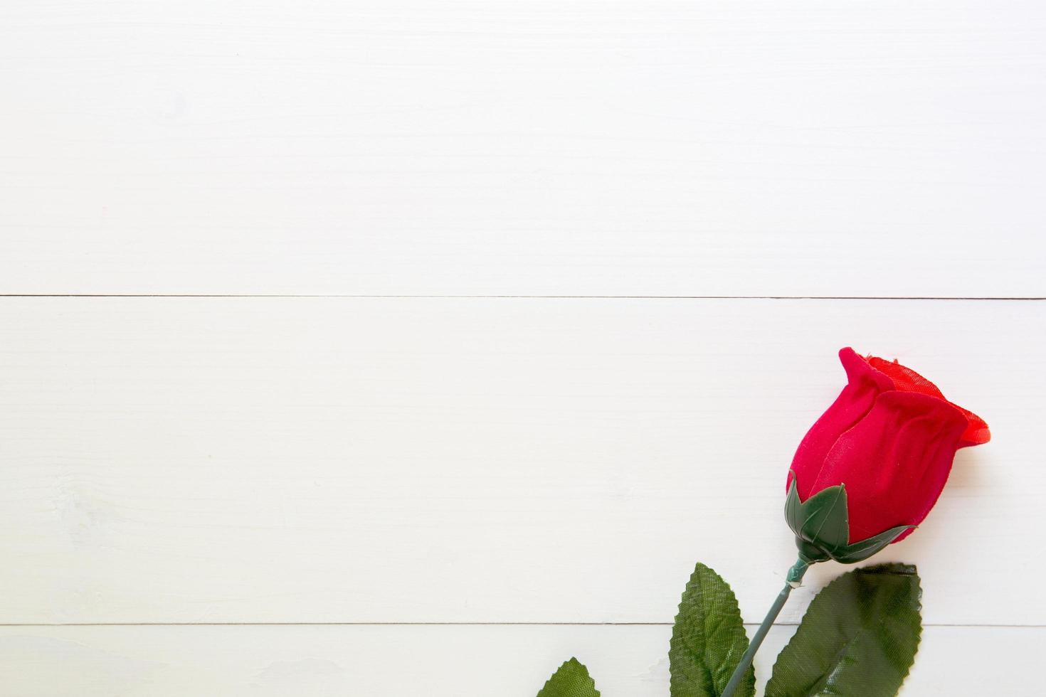 presente presente com flor rosa vermelha na mesa de madeira, 14 de fevereiro do dia do amor com romântico, conceito de férias dos namorados, vista superior. foto