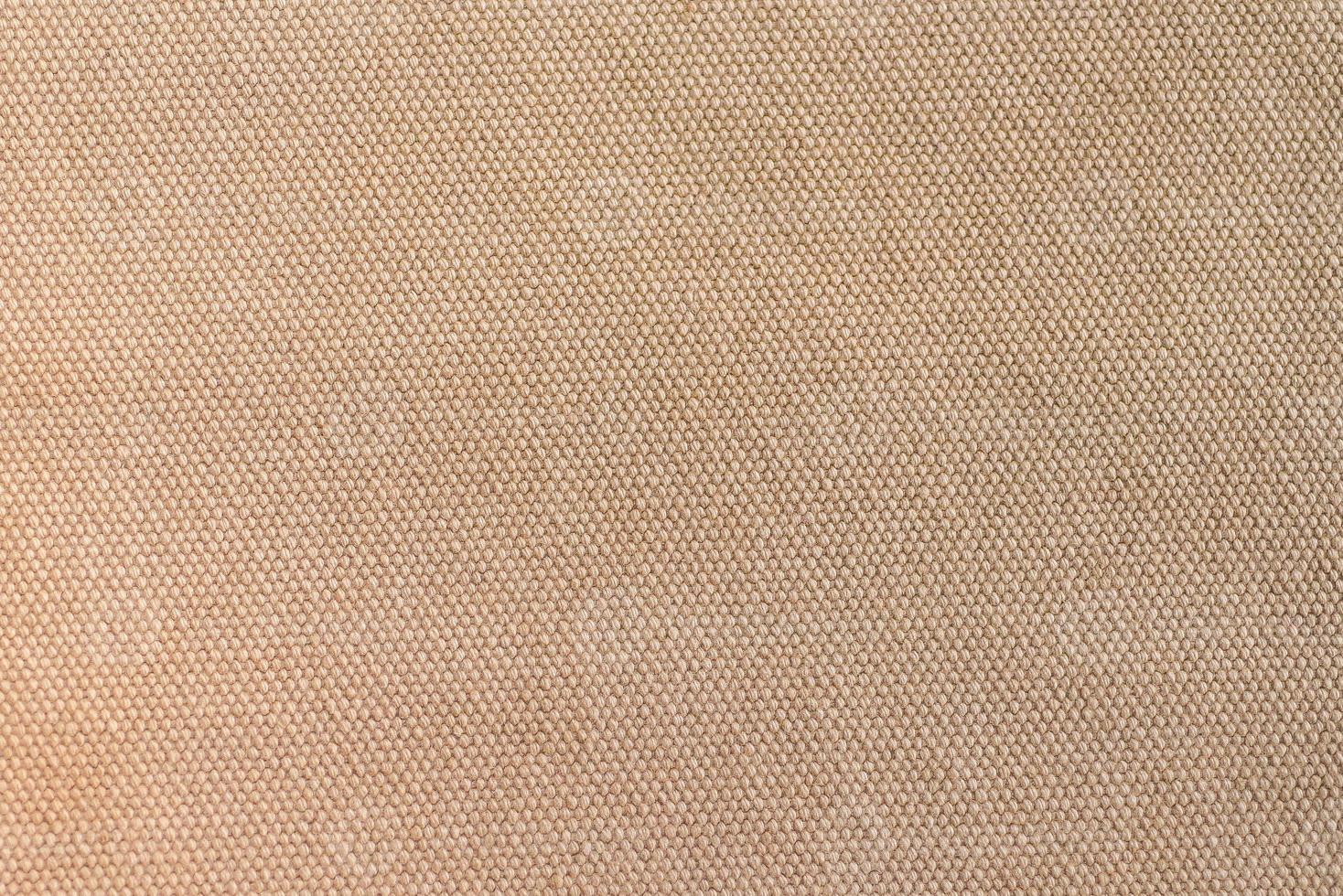 textura de close-up de tecido de lona marrom claro como plano de fundo foto