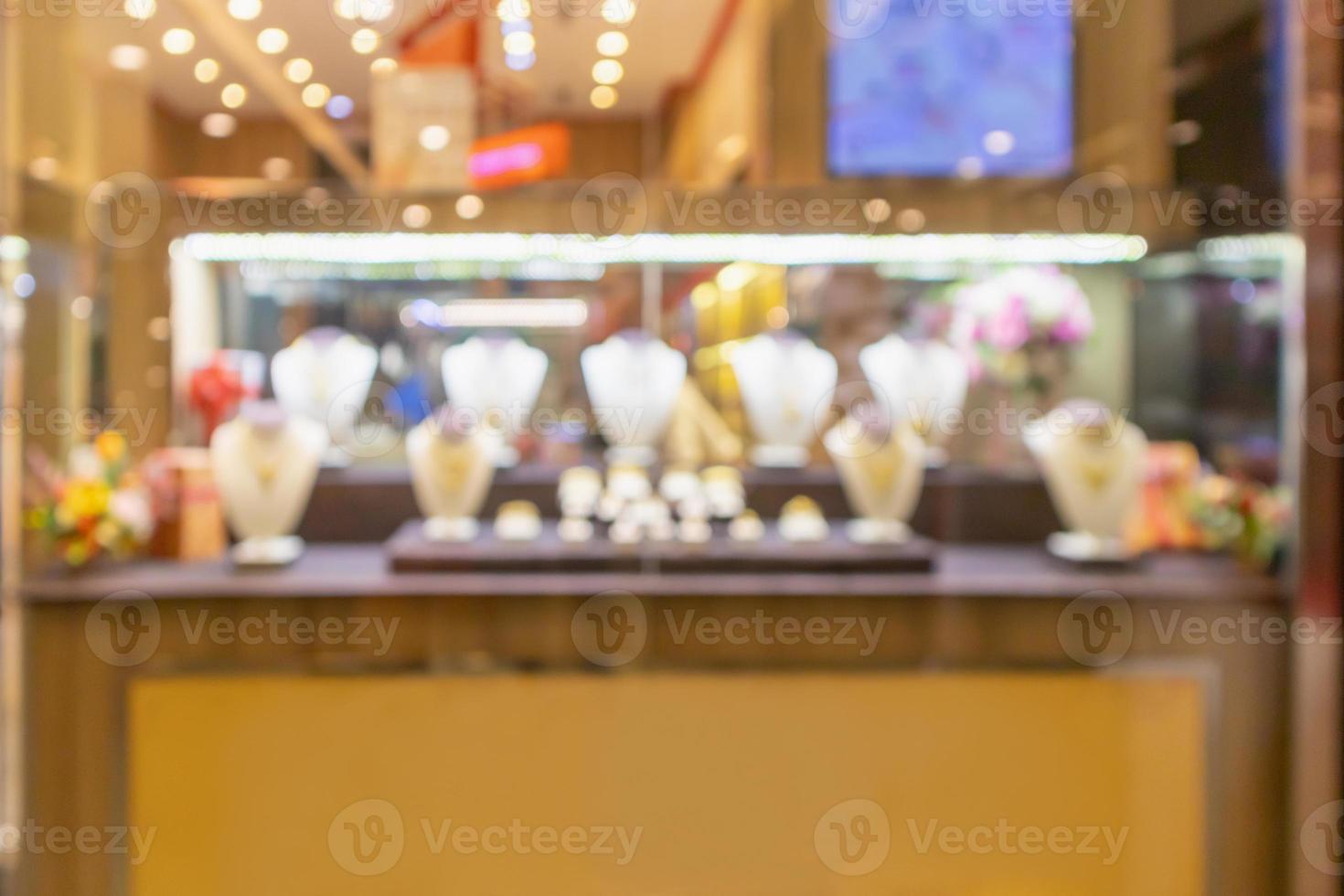 Borrão abstrato de vitrine de loja de diamantes de joias de ouro com fundo claro de bokeh foto