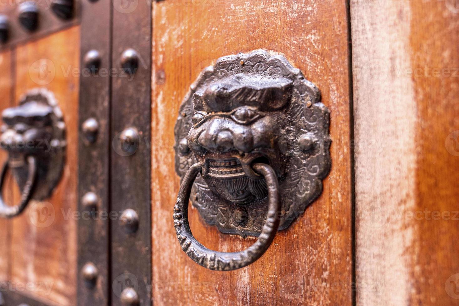 detalhe da aldrava metálica velha ou alça na porta de madeira foto