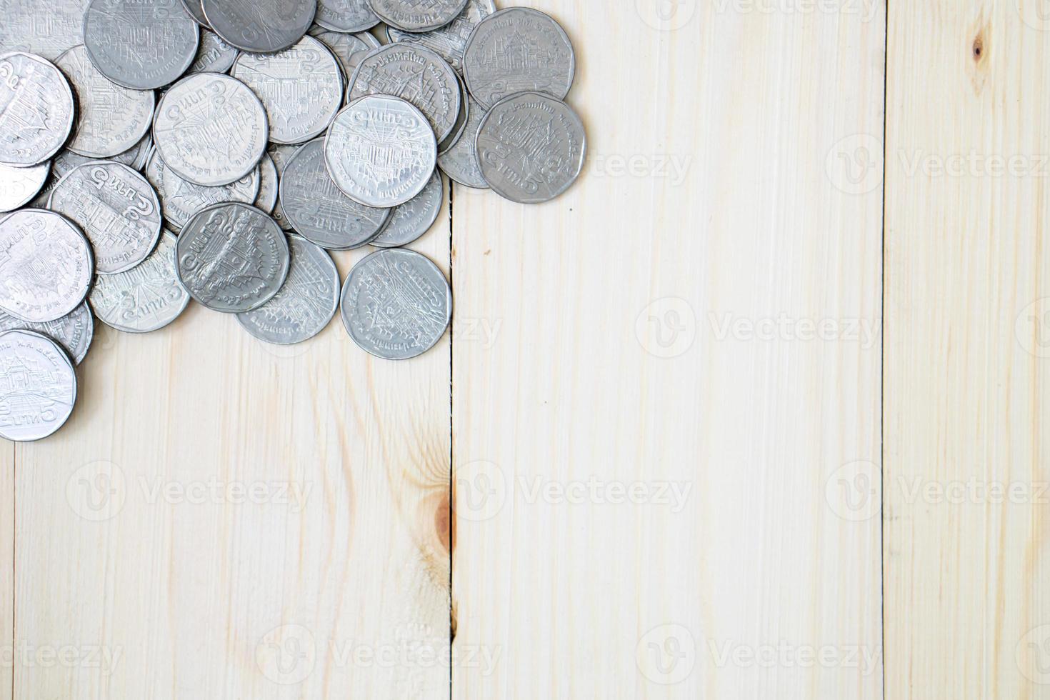 moedas em fundo de madeira foto
