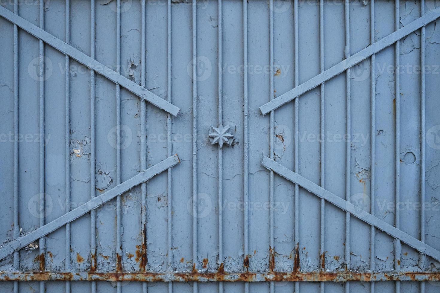 velhos portões de ferro enferrujados, cobertos de tinta e detritos, foto frontal. textura de porta de metal cinza da era soviética.