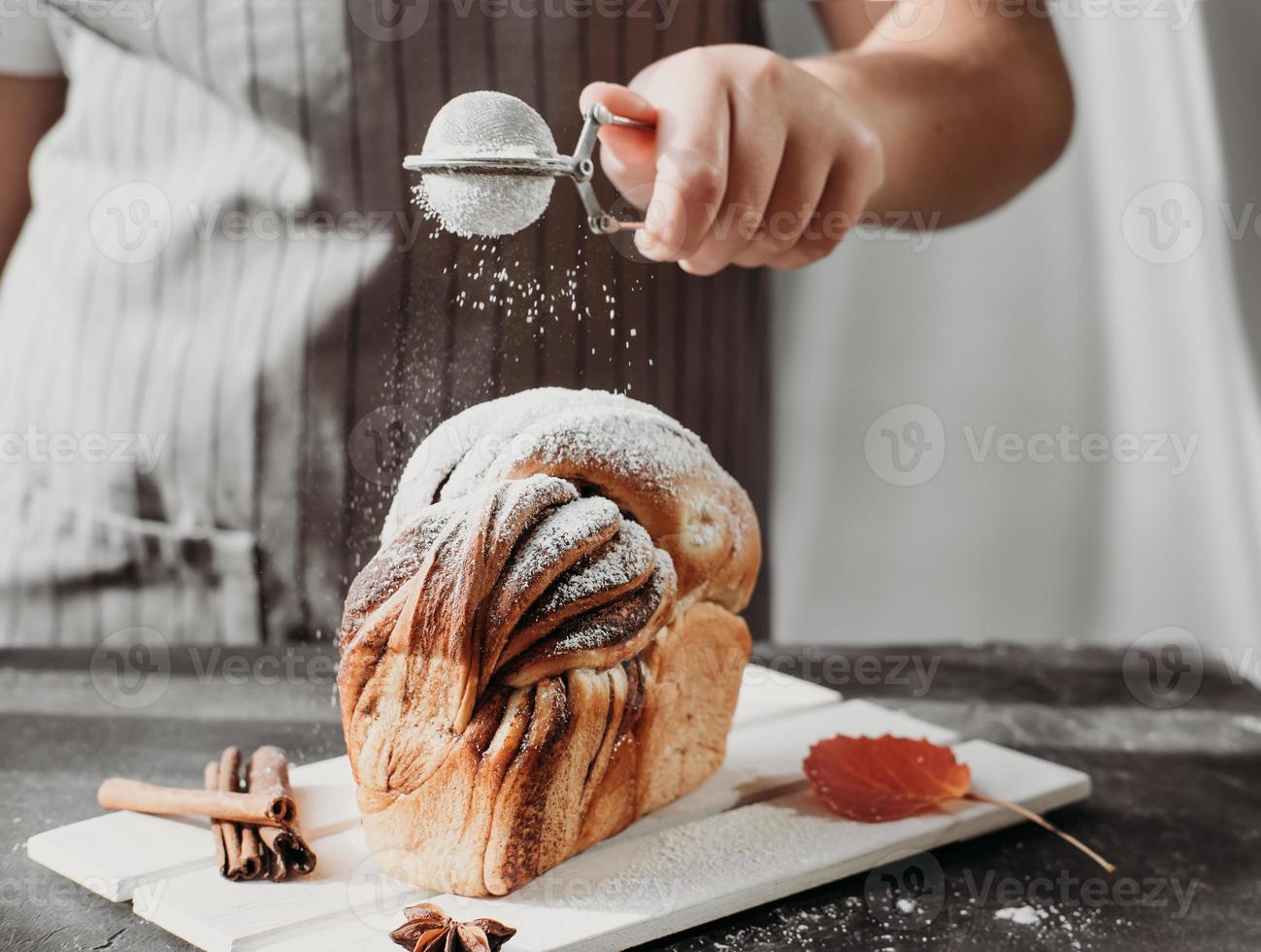 pão artesanal de redemoinho de canela em rack de madeira foto