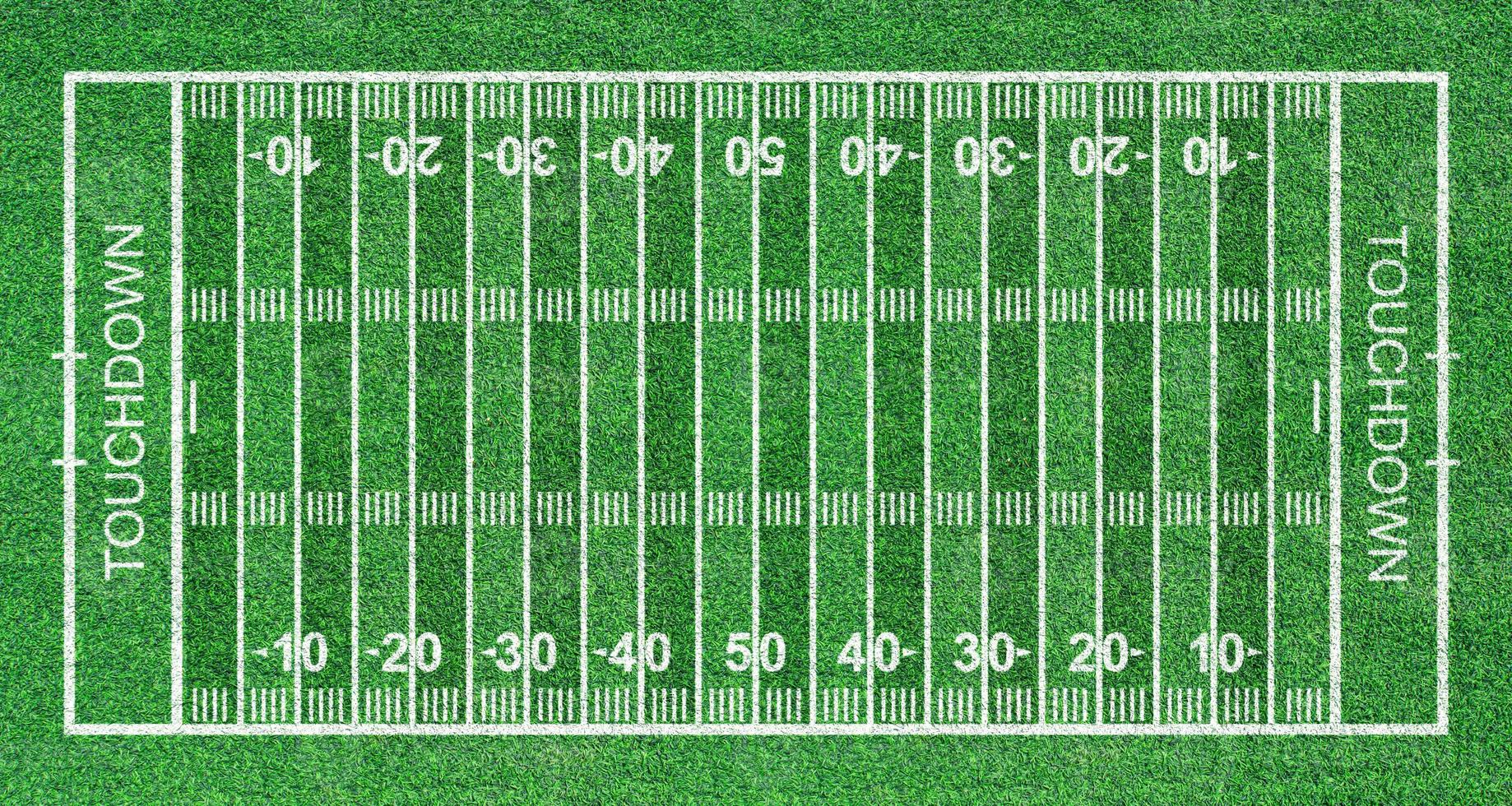 campo de futebol americano, grama listrada com linhas brancas padrão. vista do topo foto