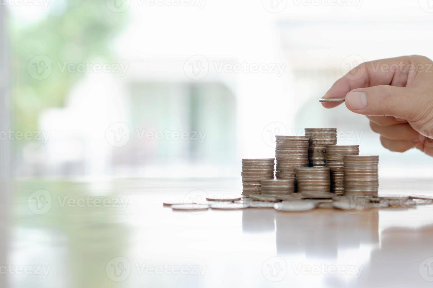 mão dando moedas no conceito de pilha, negócios e finanças foto