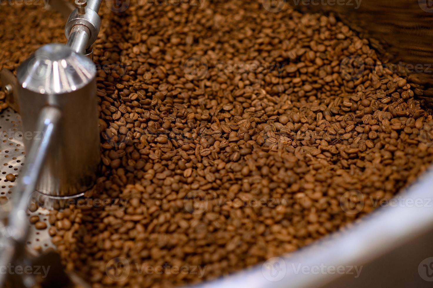 close-up vista de grãos de café torrando na máquina foto