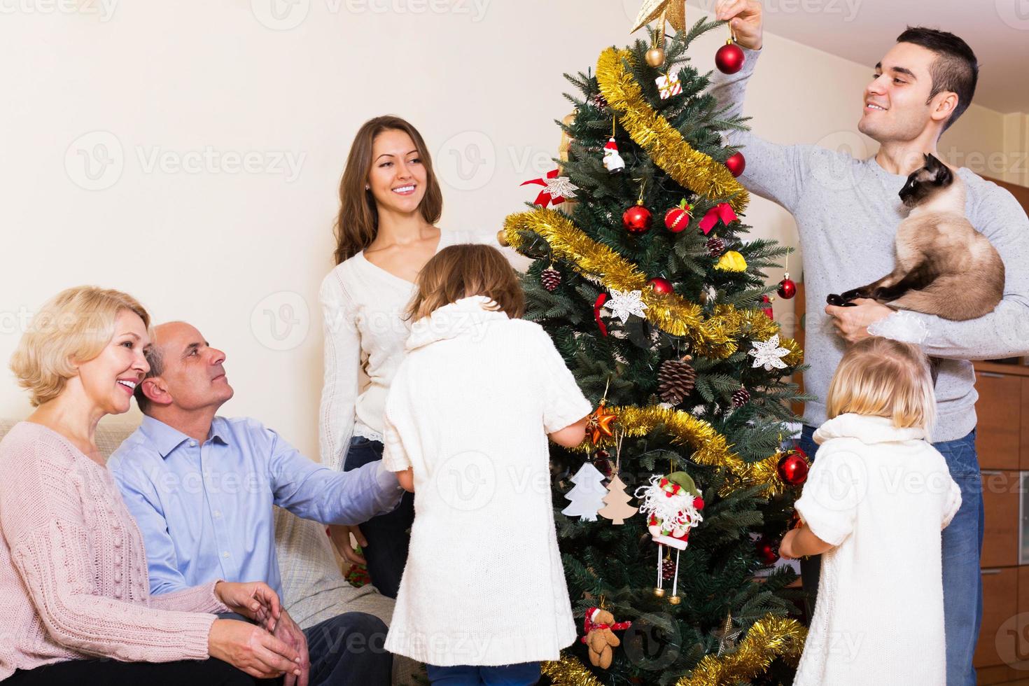família na árvore de natal foto