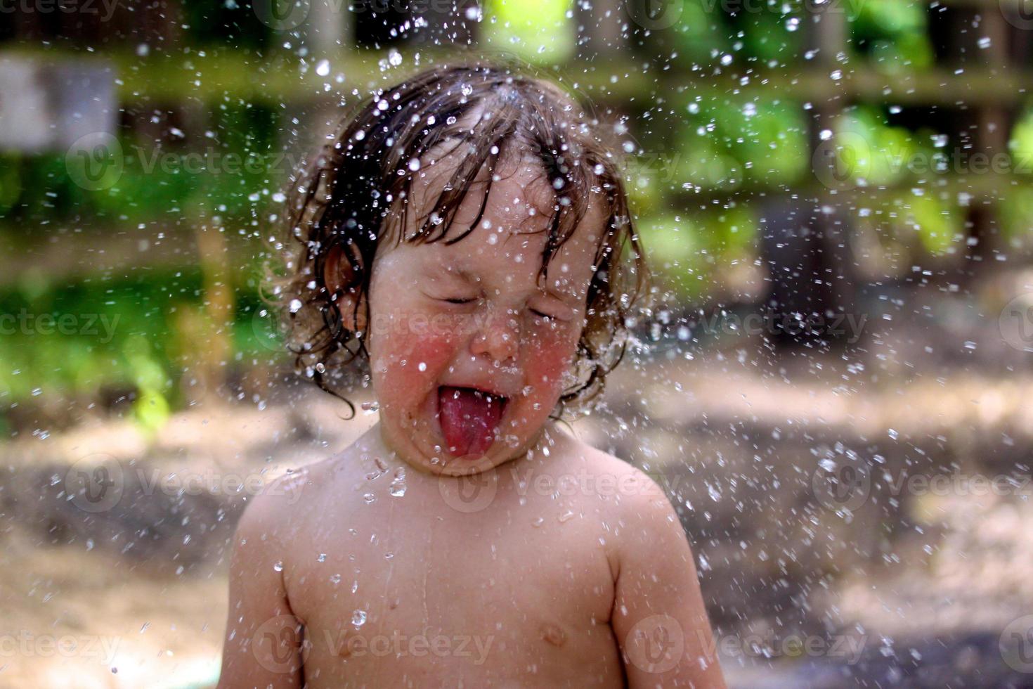 água no rosto de um bebê foto