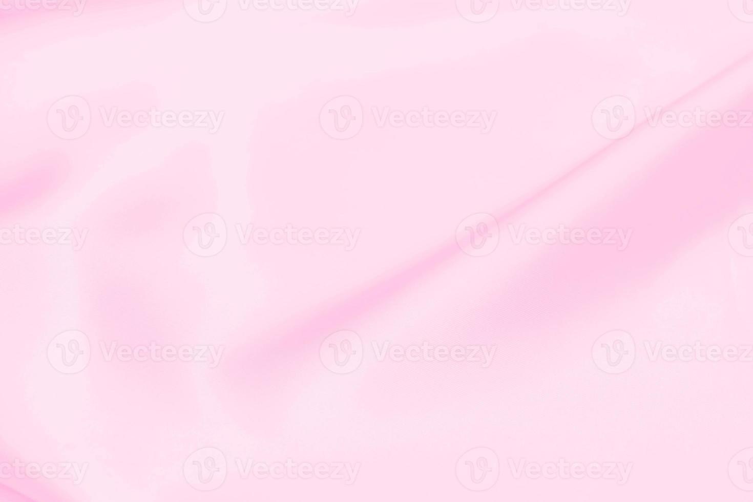 fundo de desfoque suave de textura de tecido de cetim rosa plástico foto
