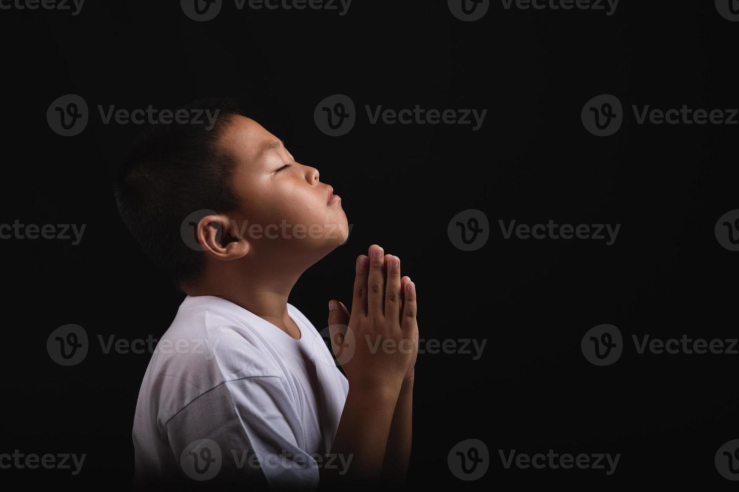 menino orando a deus em casa foto