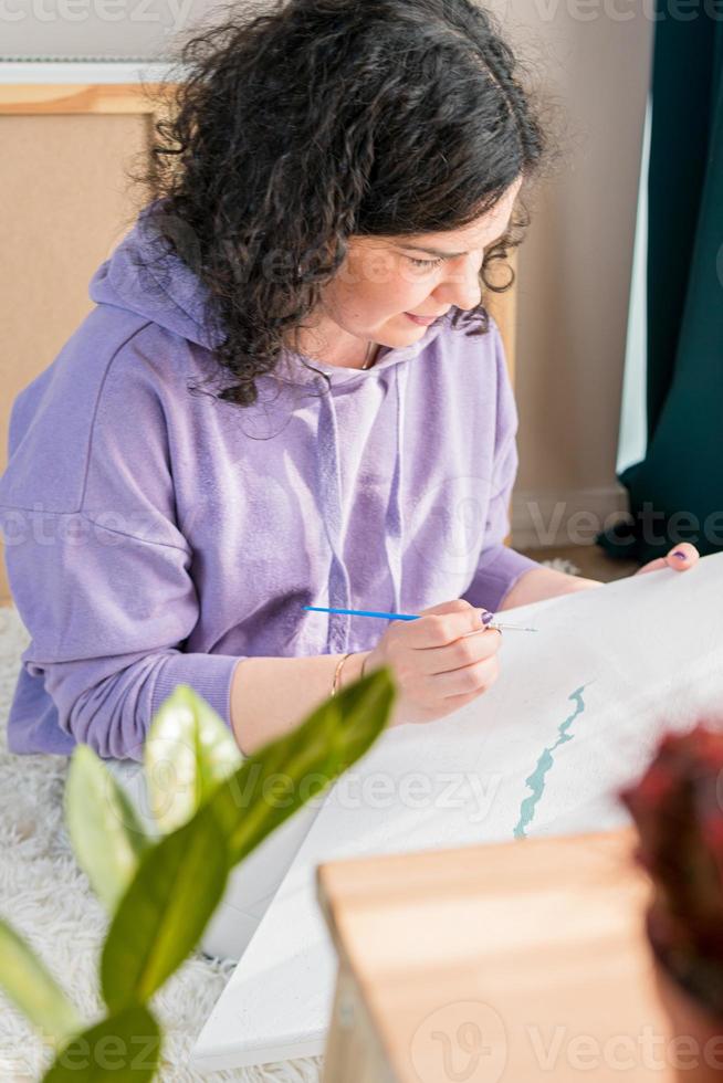a mulher adulta pintando por números, cores pastel, desenhando em tela foto