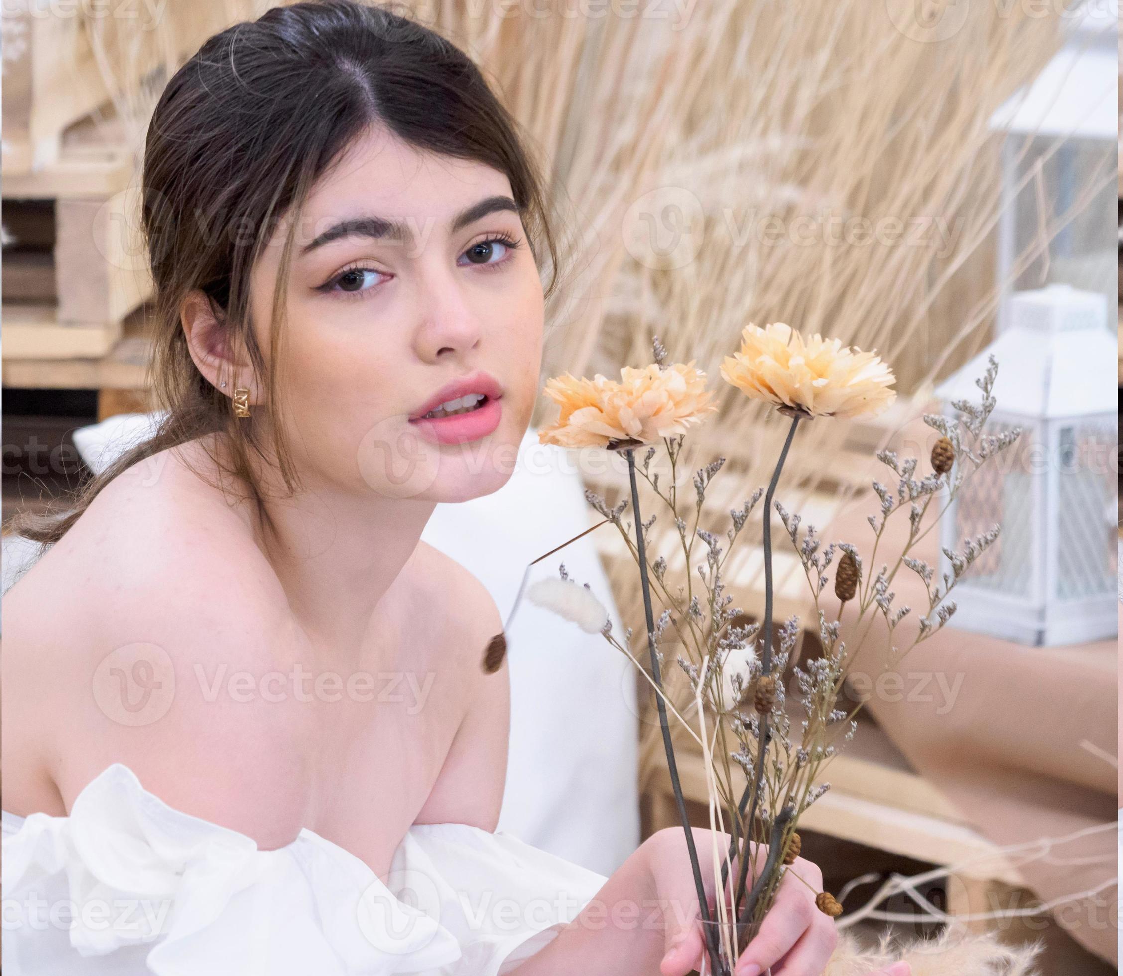 Beleza. close-up de menina bonita e natural com sorriso branco e ombros nus  rindo, sorrindo despreocupado. mulher jovem sem maquiagem mostrando efeito  após cosméticos, parede branca