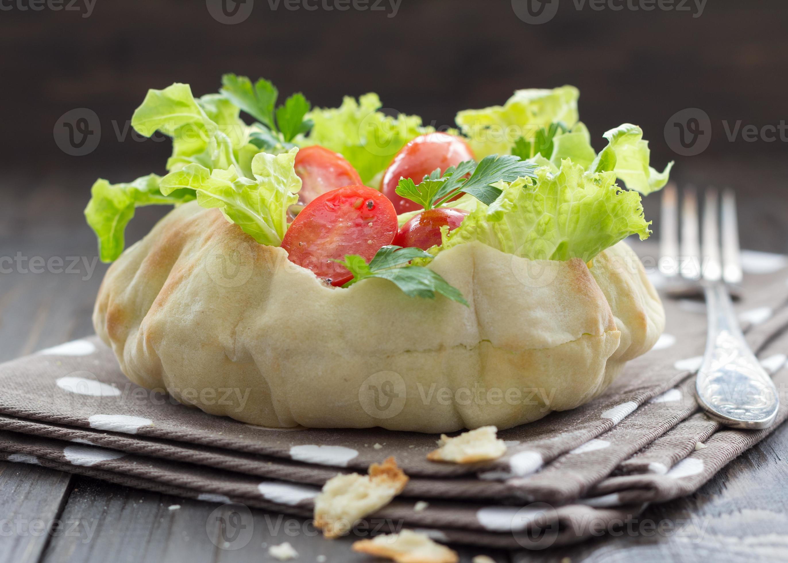 salada em uma tigela de pão foto