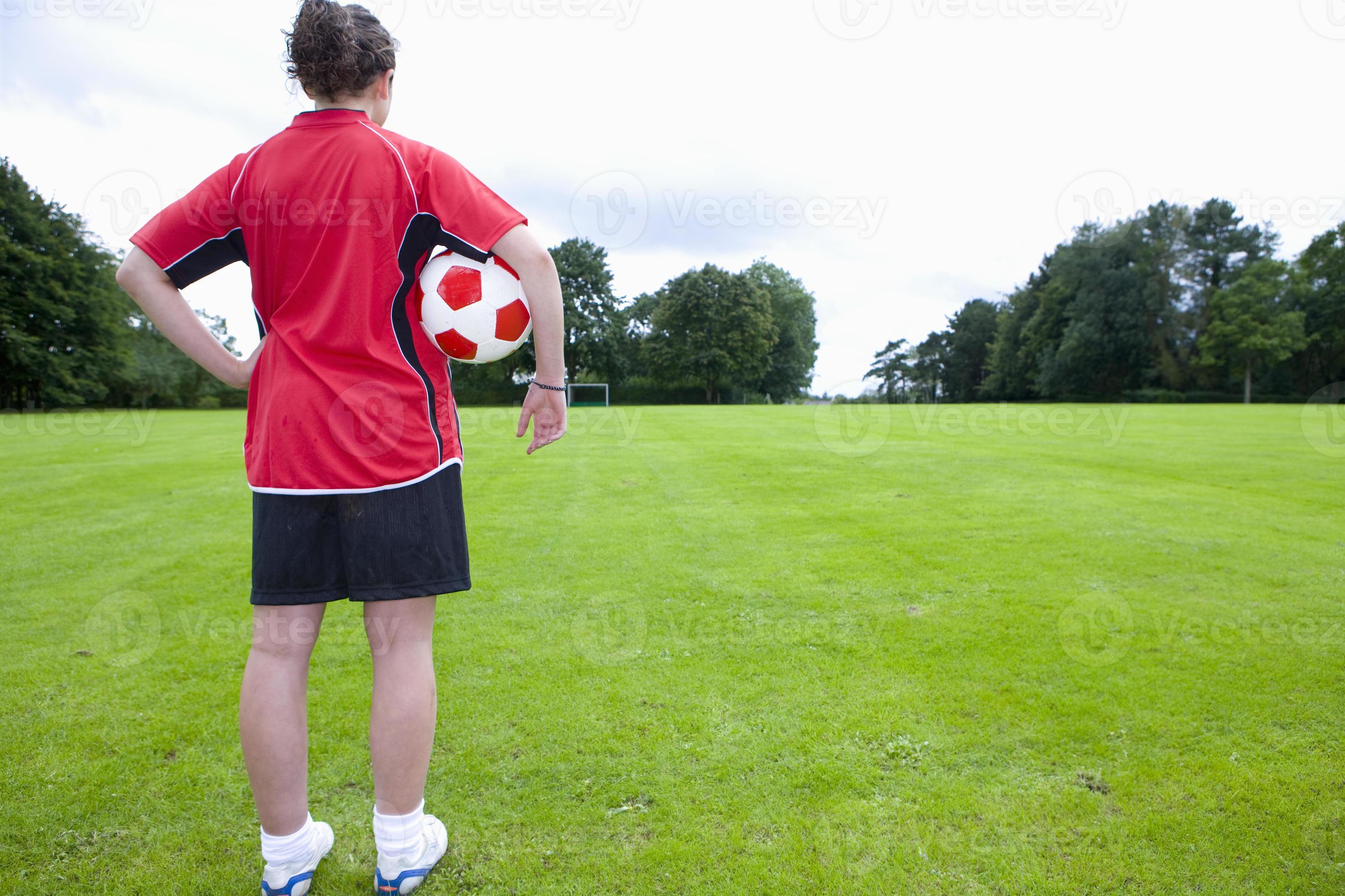 Jogador de futebol colocando a bola na grama ângulo baixo do