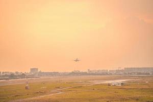 cidade de ho chi minh, vietnã - 12 de fevereiro de 2022 avião sobrevoa áreas urbanas preparando o pouso no aeroporto internacional tan son nhat e decola no aeroporto tsn foto