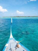 incrível design de praia das maldivas. Maldivas barco tradicional dhoni frente. mar azul perfeito com lagoa oceânica. conceito de paraíso tropical de luxo. bela paisagem de viagens de férias. lagoa oceânica tranquila foto