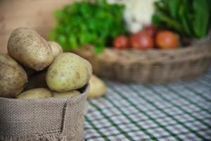 batata fresca na cozinha pronta para ser cozida - preparação de vegetais frescos para fazer o conceito de comida foto