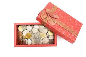 caixa de presente aberta com moedas no fundo branco foto