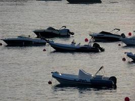 pequenos barcos de recreio e esporte ancorados no meio da baía na costa brava catalã. foto