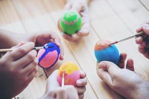 pessoas pintando ovos de páscoa coloridos - conceito de feriado nacional de celebração de pessoas foto