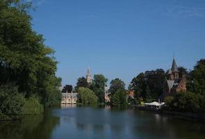 castelo gótico de minnewater no lago do amor em bruges, bélgica, dia ensolarado, bela paisagem natural foto