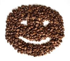 closeup de grãos de café torrados com sorriso no fundo branco foto