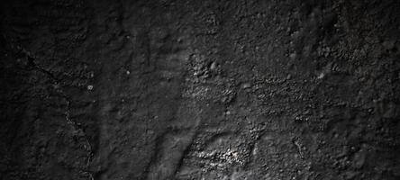 fundo de pedra preta escura. textura de concreto preto assustador. fundo da parede de pedra. foto