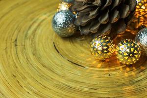 bola de natal e pinhas em fundo de madeira. foto