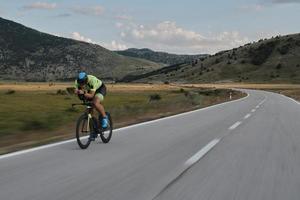 atleta de triatlo andando de bicicleta foto