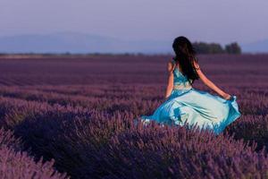 mulher no campo de flores de lavanda foto