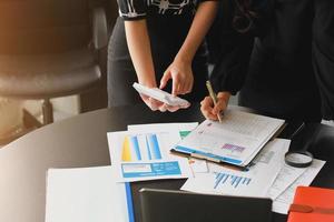 empresários reunidos para analisar e discutir e debater os dados do gráfico do relatório financeiro no trabalho em equipe do consultor financeiro do escritório e no conceito de contabilidade. foto