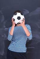 mulher segurando uma bola de futebol na frente da prancheta de giz foto