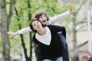 menina feliz e mãe ao ar livre foto