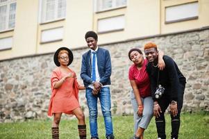 quatro amigos africanos se divertindo e dançando ao ar livre. duas meninas negras com caras. foto