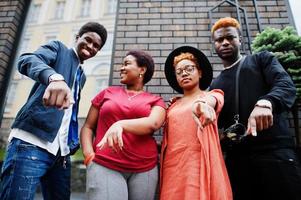quatro amigos africanos se divertindo ao ar livre. duas meninas negras com caras. foto