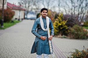 homem indiano usa roupas tradicionais com lenço branco posado ao ar livre. foto