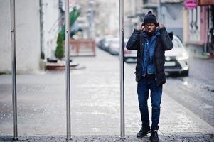 homem africano usar jaqueta e chapéu preto no tempo frio posou ao ar livre. foto