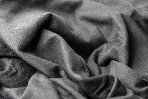 fechar a textura têxtil de fundo de roupas pretas foto