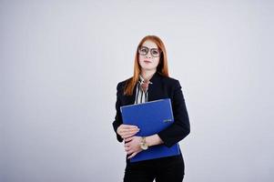 retrato de uma empresária ruiva vestindo blusa listrada e uma jaqueta com uma pasta azul. foto