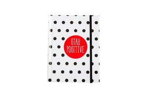 caderno de bolinhas preto e branco com circla vermelha e inscrição positiva na capa. foto