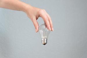 mão de mulher segurando a lâmpada. ideia e conceito de negócios. foto