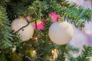 close-up da árvore de natal decorada com guirlanda de bolas brancas. fundo de ano novo foto