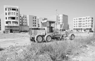 máquina de escavadeiras com rodas no canteiro de obras, máquinas pesadas e equipamentos de construção, fotografia em preto e branco foto