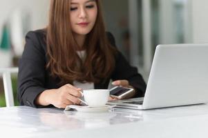 mulher asiática no café com laptop e café, conceito do negócio